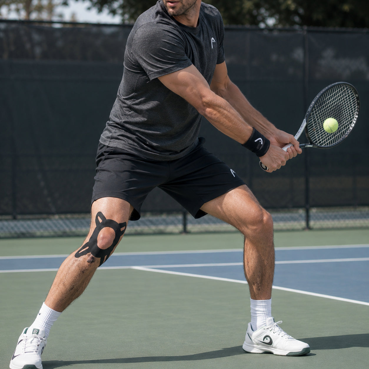 Man spelar tennis med svart förklippt kinesiologitejp applicerad runt knät.